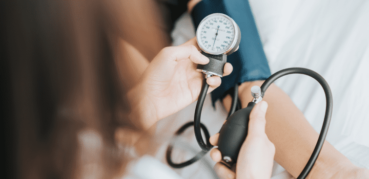 Medical professional taking patient blood pressure