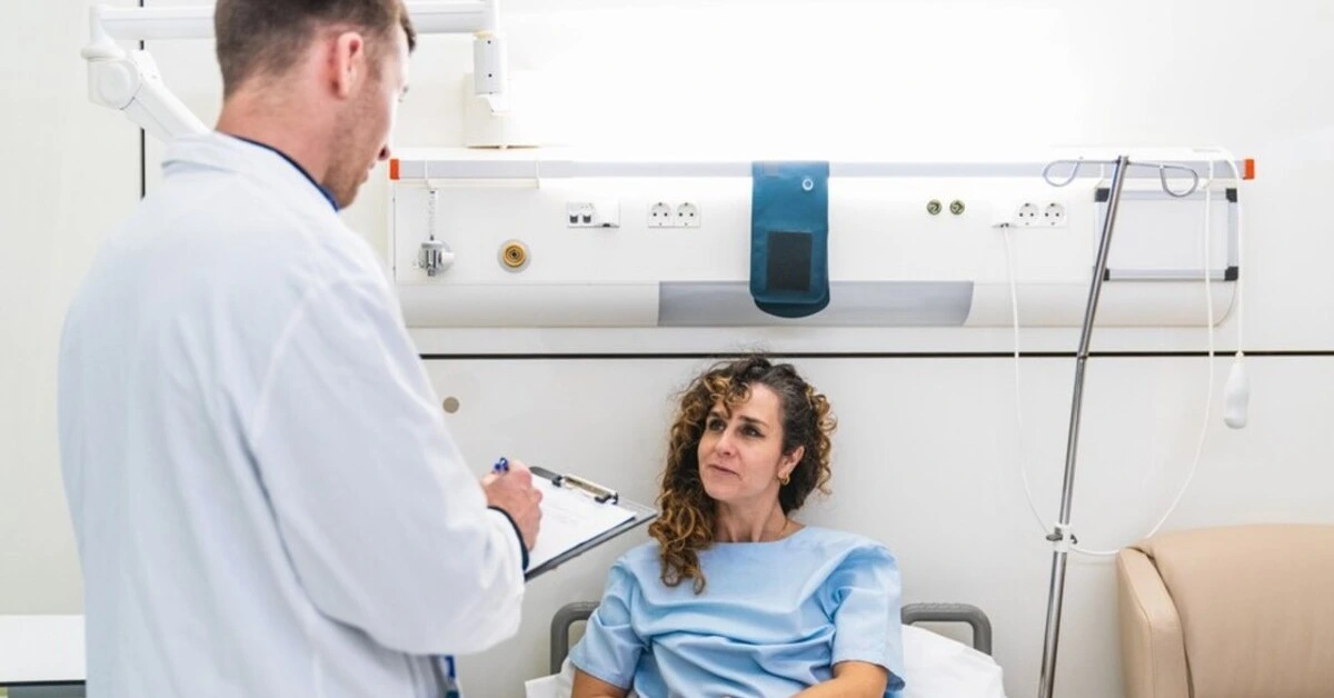 Doctor discussing medical condition with patient in hospital